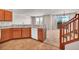 Kitchen with wood cabinets, tile floor, and access to living room and stairs at 17359 Waterhouse Cir # C, Parker, CO 80134