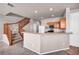 Kitchen with light wood cabinets, stainless steel appliances, and breakfast bar at 17359 Waterhouse Cir # C, Parker, CO 80134