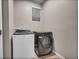 Laundry room with modern appliances and tile flooring at 17359 Waterhouse Cir # C, Parker, CO 80134
