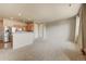 Open-concept living room showcases stainless steel appliances and neutral color scheme at 17359 Waterhouse Cir # C, Parker, CO 80134