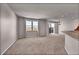 The open-concept living room has large windows, sliding glass door, and neutral paint tones at 17359 Waterhouse Cir # C, Parker, CO 80134