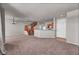 Spacious living room featuring stairs, wood railing, and an open kitchen with modern cabinets at 17359 Waterhouse Cir # C, Parker, CO 80134