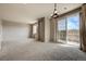 The open-concept living room showcases a sliding glass door and a modern light fixture at 17359 Waterhouse Cir # C, Parker, CO 80134