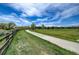 Community walking path surrounded by grass and trees at 17359 Waterhouse Cir # C, Parker, CO 80134