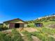 Exterior shot of barn with open bay door at 1151 Castlewood Pl, Franktown, CO 80116