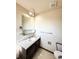 Bathroom with a single sink vanity, large mirror, and overhead lighting at 1151 Castlewood Pl, Franktown, CO 80116