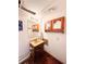 Bathroom with a dark wood vanity, mirror, and cabinet at 1151 Castlewood Pl, Franktown, CO 80116