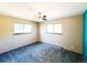 Bedroom with neutral walls, two windows for ample light, and blue carpeted floors at 1151 Castlewood Pl, Franktown, CO 80116