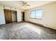 Bright bedroom featuring a large window, a ceiling fan, and closet at 1151 Castlewood Pl, Franktown, CO 80116
