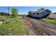 Exterior of home with a long dirt driveway and yard at 1151 Castlewood Pl, Franktown, CO 80116