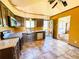 Practical kitchen with stainless appliances, neutral countertops, and eat-in space at 1151 Castlewood Pl, Franktown, CO 80116