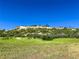 Lush green landscape with rocky hill at 1151 Castlewood Pl, Franktown, CO 80116