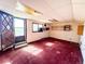 Bright room with red carpet, a wooden door, and a window at 1151 Castlewood Pl, Franktown, CO 80116