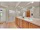 Bright bathroom features a double sink vanity with wood cabinets, large mirror, and a glass-enclosed shower at 153 Gold Run Trl, Idaho Springs, CO 80452