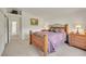 Well-lit bedroom featuring carpet floors, neutral walls, and traditional furniture including a patterned quilt on the bed at 153 Gold Run Trl, Idaho Springs, CO 80452