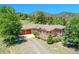 Charming ranch-style home with a large deck, wooden garage doors, and mountain views at 153 Gold Run Trl, Idaho Springs, CO 80452