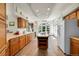 Open kitchen with tile floors, light wood cabinets, center island and stainless steel refrigerator at 153 Gold Run Trl, Idaho Springs, CO 80452