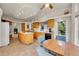 Spacious kitchen with island, wooden cabinetry, tile floors, and breakfast nook area at 153 Gold Run Trl, Idaho Springs, CO 80452