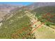 Aerial view of a large wooded property, surrounded by green trees and a clear boundary line at 153 Gold Run Trl, Idaho Springs, CO 80452