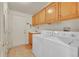 Functional laundry room with washer, dryer, sink, and storage cabinets, providing convenience for laundry tasks at 153 Gold Run Trl, Idaho Springs, CO 80452