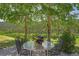 Inviting outdoor space with a glass-topped table surrounded by mature aspen trees and views of lush greenery at 153 Gold Run Trl, Idaho Springs, CO 80452