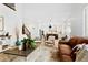 Bright living room with hardwood floors, modern furnishings, and open layout to the kitchen and staircase at 1803 S Coolidge St, Aurora, CO 80018