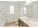 This bathroom has wood-look flooring, white marble-look shower surround, and white countertop at 20590 E 58Th Ave, Aurora, CO 80019