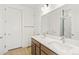 Bathroom featuring double sinks, white quartz countertops, and modern fixtures at 20590 E 58Th Ave, Aurora, CO 80019