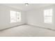 Bright bedroom featuring large windows offering plenty of natural light and neutral carpeting at 20590 E 58Th Ave, Aurora, CO 80019