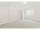 Bright bedroom with closet and window boasts neutral carpet and white walls at 20590 E 58Th Ave, Aurora, CO 80019