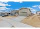 The exterior of this house features neutral-colored siding, a covered porch, and a two-car garage at 20590 E 58Th Ave, Aurora, CO 80019