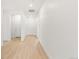Entryway hallway with light wood flooring and white walls with views to the front door at 20590 E 58Th Ave, Aurora, CO 80019
