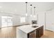 Spacious kitchen with quartz countertop island and an open floor plan flowing into the living area at 20590 E 58Th Ave, Aurora, CO 80019