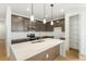 Beautiful kitchen with quartz countertop island, stainless steel appliances, and pendant lighting at 20590 E 58Th Ave, Aurora, CO 80019