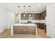 Modern kitchen featuring an island with a sink and stainless steel appliances at 20590 E 58Th Ave, Aurora, CO 80019