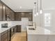 Modern kitchen with stainless steel appliances and a quartz countertop island at 20590 E 58Th Ave, Aurora, CO 80019