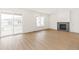 Spacious living room with a cozy fireplace and access to an outdoor deck at 20590 E 58Th Ave, Aurora, CO 80019