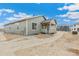 The home's rear exterior features a covered porch and neutral siding at 20590 E 58Th Ave, Aurora, CO 80019