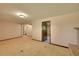 Spacious unfinished basement featuring tile flooring, ample space, and a vintage fireplace at 7448 W Geddes Pl, Littleton, CO 80128