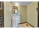 Small bathroom with a sink with white wooden cabinets and a mirror hanging above it at 7448 W Geddes Pl, Littleton, CO 80128