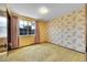 Bedroom featuring yellow walls, floral wallpaper, and a window with curtains for natural light at 7448 W Geddes Pl, Littleton, CO 80128