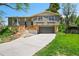 Charming split-level home featuring a newly built deck and attached two-car garage at 7448 W Geddes Pl, Littleton, CO 80128