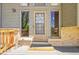 Close up of front door featuring new wooden deck and painted trim at 7448 W Geddes Pl, Littleton, CO 80128