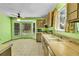 A bright kitchen featuring original cabinetry, appliances, and a spacious dining area at 7448 W Geddes Pl, Littleton, CO 80128