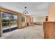 Spacious living room featuring a sliding glass door and large windows with abundant natural light at 7448 W Geddes Pl, Littleton, CO 80128