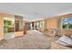 Spacious living room featuring neutral colored walls, lots of light and sliding glass doors to a balcony at 7448 W Geddes Pl, Littleton, CO 80128