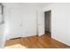 Bedroom featuring hardwood floors, white walls, and a closet at 35 S Cody St, Lakewood, CO 80226