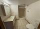Functional bathroom features a tiled floor, shower, and standard vanity at 6921 S Bryant St, Littleton, CO 80120