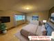 Staged primary bedroom with a large bed and a window overlooking the backyard at 6921 S Bryant St, Littleton, CO 80120