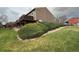 Residential exterior view featuring lush landscaping and multi-level townhomes with decks at 6921 S Bryant St, Littleton, CO 80120